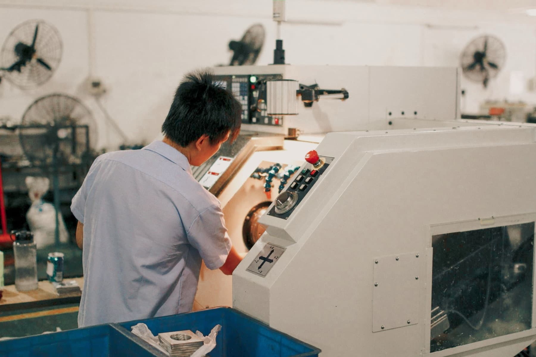 A person operating a workshop machine
